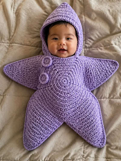 Hand-crocheted starfish suit in Lavender, on a baby